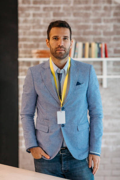 Businessman with name tag standing in his office